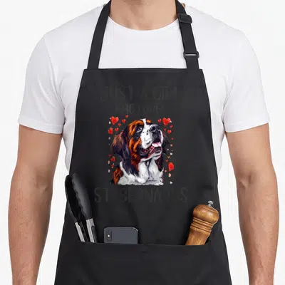 Owner saint bernard apron - Realistic St Bernard head with red hearts and text Just a Girl Who Loves St Bernards — shown on a black cotton canvas apron against a white background