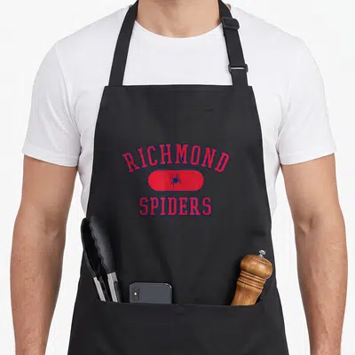 Richmond richland apron - Red and blue varsity RICHMOND SPIDERS text with spider inside red oval — shown on a black cotton canvas apron against a white background