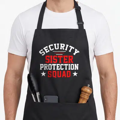 Bday sister squad apron - Red and white SECURITY SISTER PROTECTION SQUAD text with two white stars stacked vertically — shown on a black cotton canvas apron against a white background