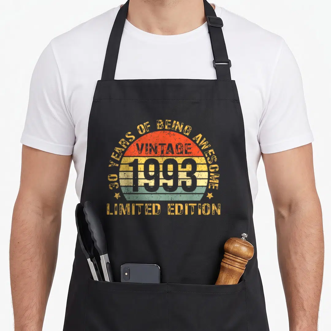 30th bday birthday apron - Striped retro sunset with 1993 text and 30 years of being awesome arch — shown on a black cotton canvas apron against a white background