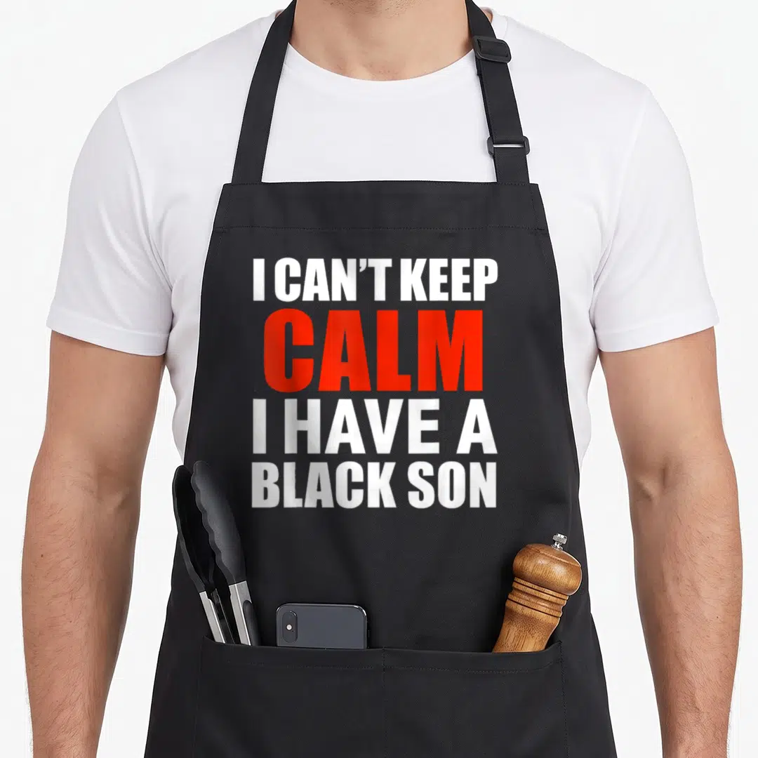 Son novelty apron - Stacked white and red text reading I CAN'T KEEP CALM I HAVE A BLACK SON — shown on a black cotton canvas apron against a white background