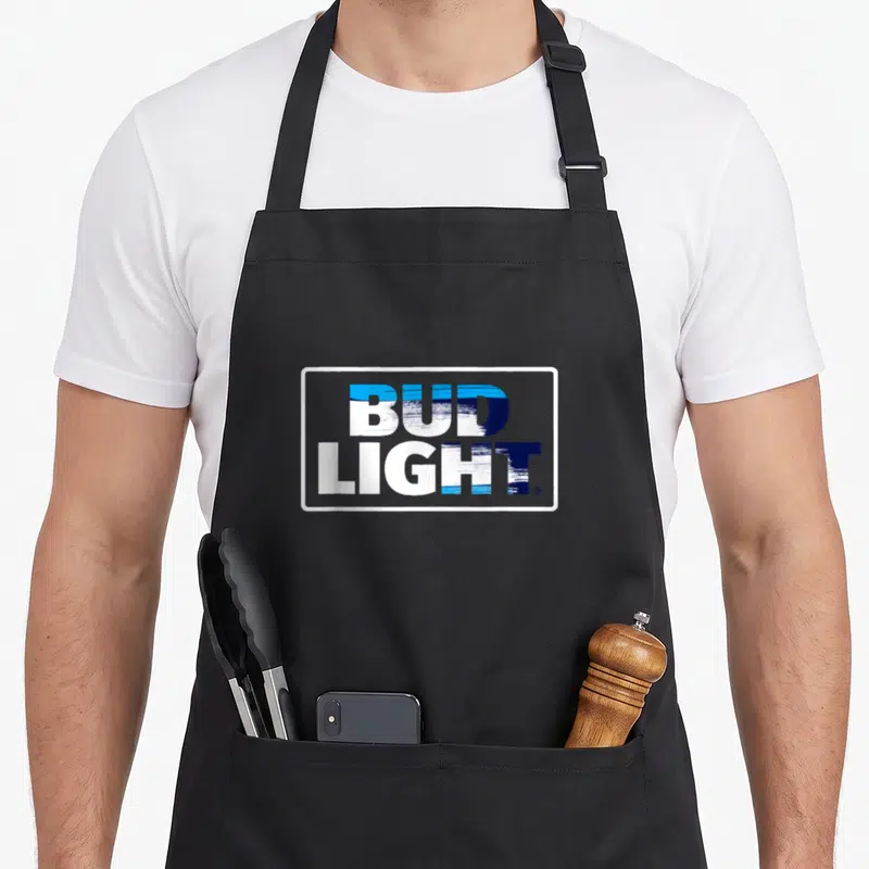Bud logo officially apron - Blue and white BUD LIGHT text logo in a white rectangular border with brush stroke texture — shown on a black cotton canvas apron against a white background