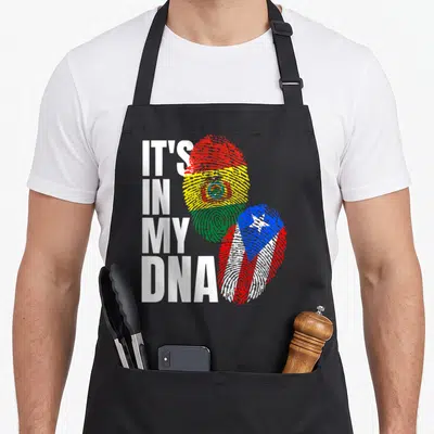 Rican bolivian heritage aprons - IT'S IN MY DNA text beside two fingerprints filled with Bolivian and Puerto Rican flag — shown on a black cotton canvas apron against a white background