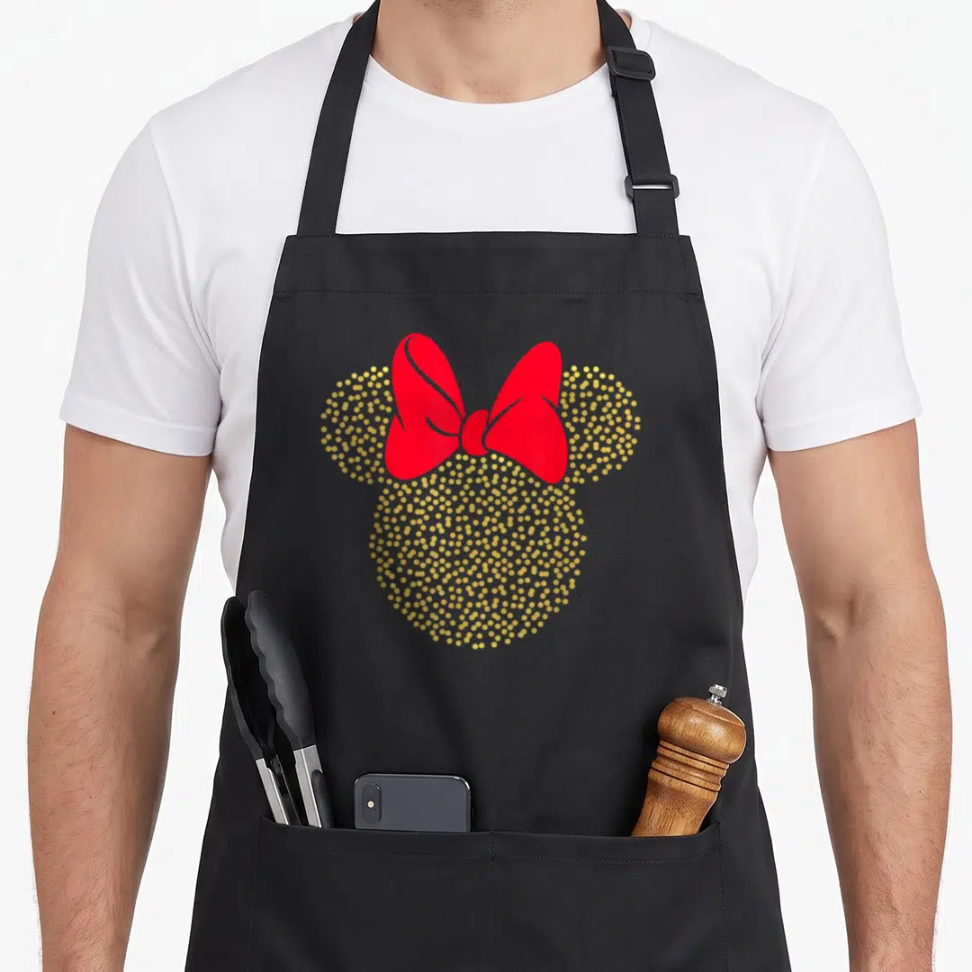 Dotted crazy mouse lady apron - Mouse head silhouette made of gold dots with a large red bow between ears — shown on a black cotton canvas apron against a white background