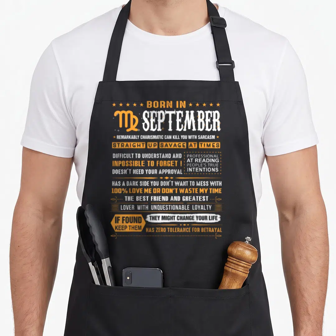 September virgo birthday apron - BORN IN SEPTEMBER Virgo typography with orange boxes and stars listing sarcastic — shown on a black cotton canvas apron against a white background
