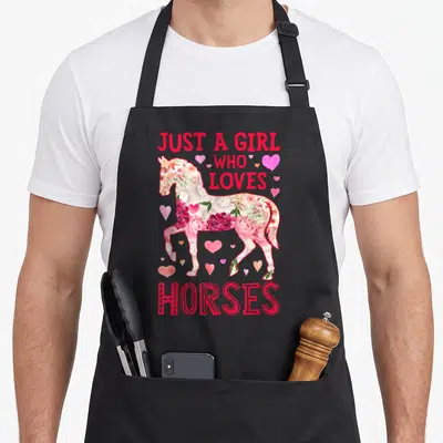 Horse horseback riding farm apron - Floral horse silhouette with Just A Girl Who Loves Horses text and pink hearts — shown on a black cotton canvas apron against a white background