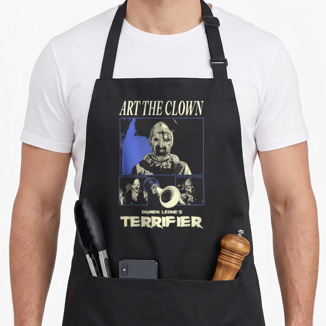 Panel clown aprons - Distressed beige blue grey Art the Clown Terrifier text and masked clown panels with hammer — shown on a black cotton canvas apron against a white background