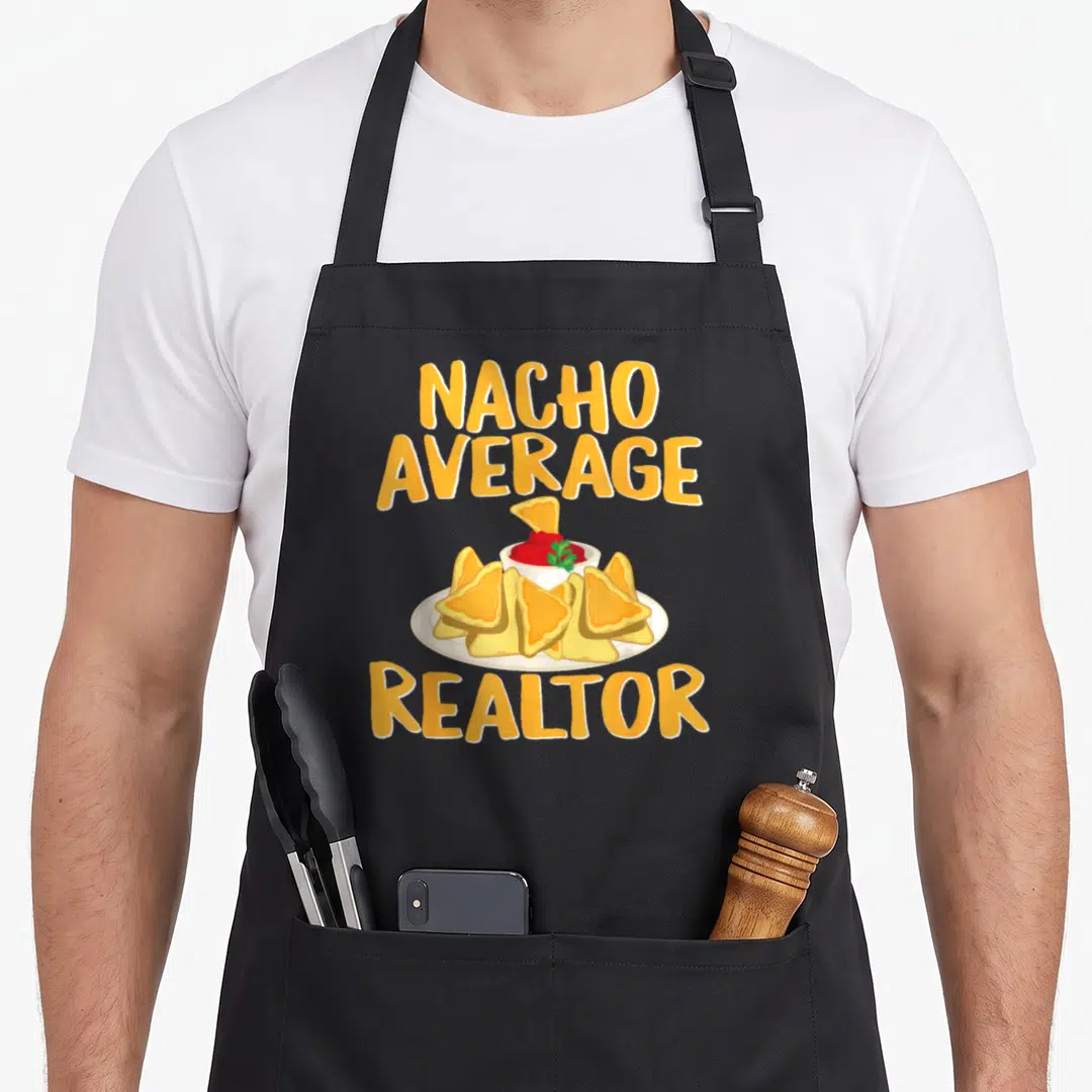 Nacho agent apron - Orange text reading Nacho Average Realtor above a plate of chips with red salsa and green garnish — shown on a black cotton canvas apron against a white background