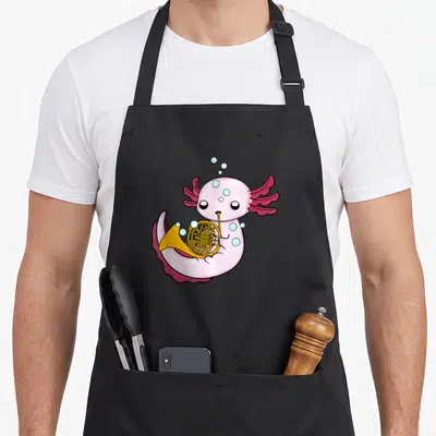 Axolotl french apron - Pink cartoon axolotl holding a gold French horn with scattered blue bubbles — shown on a black cotton canvas apron against a white background