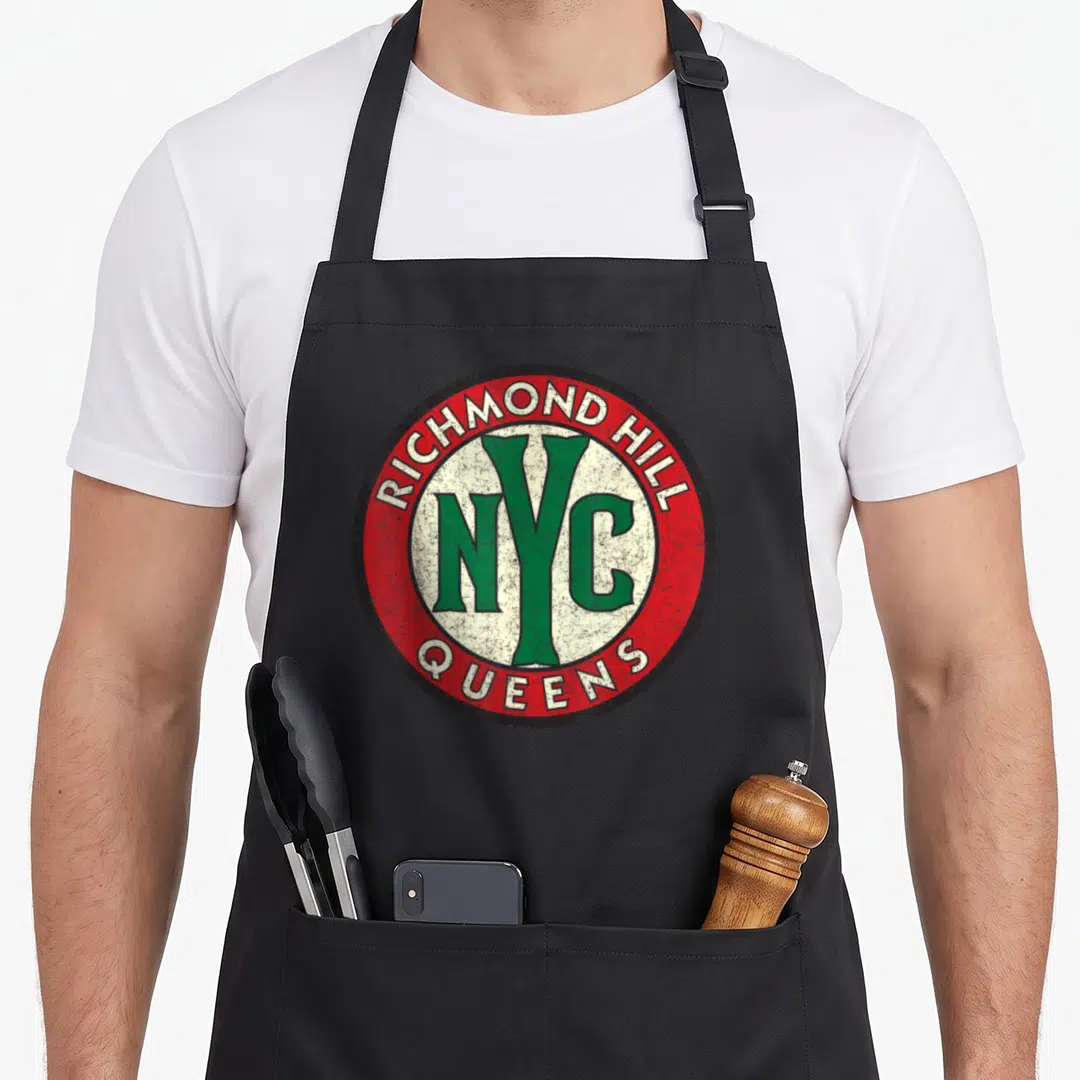 Richmond nyc apron - Distressed circular logo with red ring and green NYC text on white center — shown on a black cotton canvas apron against a white background