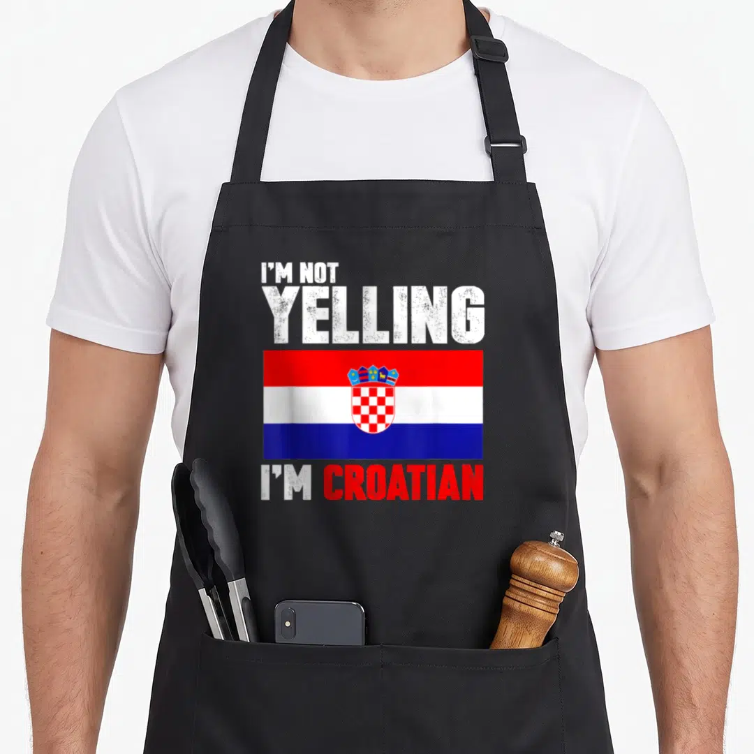 Yelling croatian aprons - I'M NOT YELLING I'M CROATIAN text above red white blue flag — shown on a black cotton canvas apron against a white background