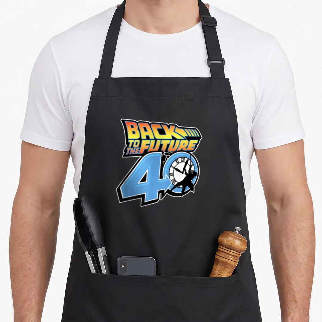 Anniversary 40th apron - Back to the Future logo blue number 40 clock silhouette retro art — shown on a black cotton canvas apron against a white background