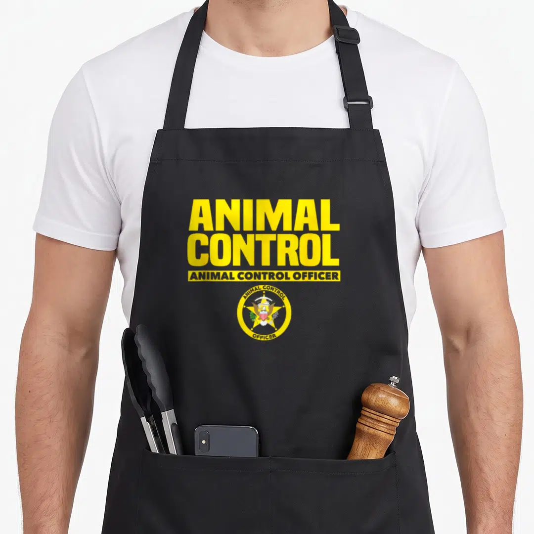 Public safety apron - Yellow ANIMAL CONTROL text above circular badge with eagle star in red blue white yellow on black — shown on a black cotton canvas apron against a white background