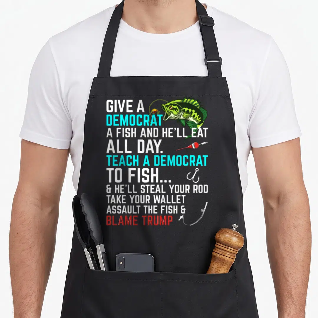 Republican fish apron - Political slogan text with green cartoon bass, red float, and fishing hook — shown on a black cotton canvas apron against a white background