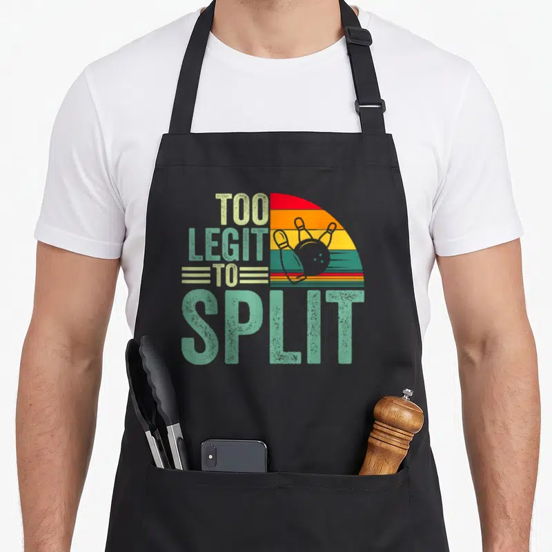 Ligit split apron - Retro bowling ball pins striped semi-circle text too legit to split — shown on a black cotton canvas apron against a white background