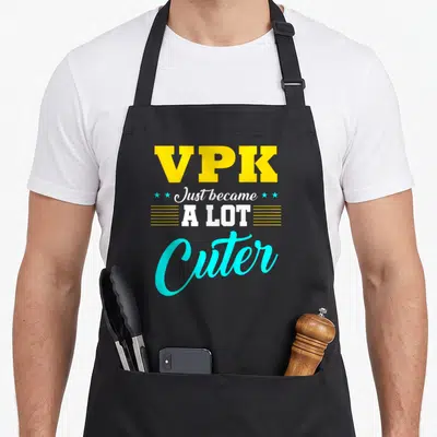 Vpk preschool apron - Yellow VPK text above white Just became A LOT Cuter script with cyan stars and lines — shown on a black cotton canvas apron against a white background