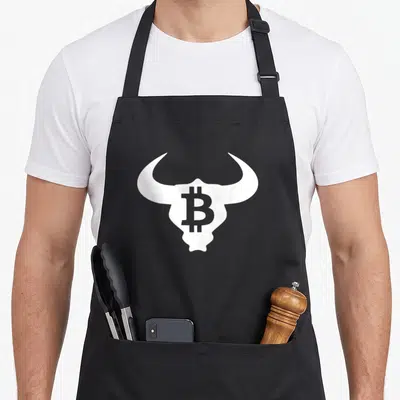 Bull bitcoin apron - White bull skull with grey Bitcoin symbol centered in forehead on grey background — shown on a black cotton canvas apron against a white background
