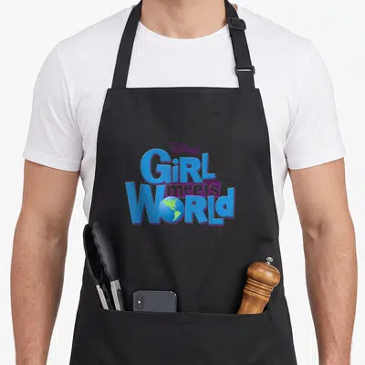 Channel meet novelty apron - Blue and purple Girl Meets World logo with a green earth globe replacing the letter O — shown on a black cotton canvas apron against a white background