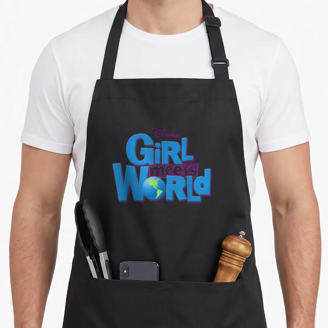Channel meet novelty apron - Blue and purple Girl Meets World logo with a green earth globe replacing the letter O — shown on a black cotton canvas apron against a white background