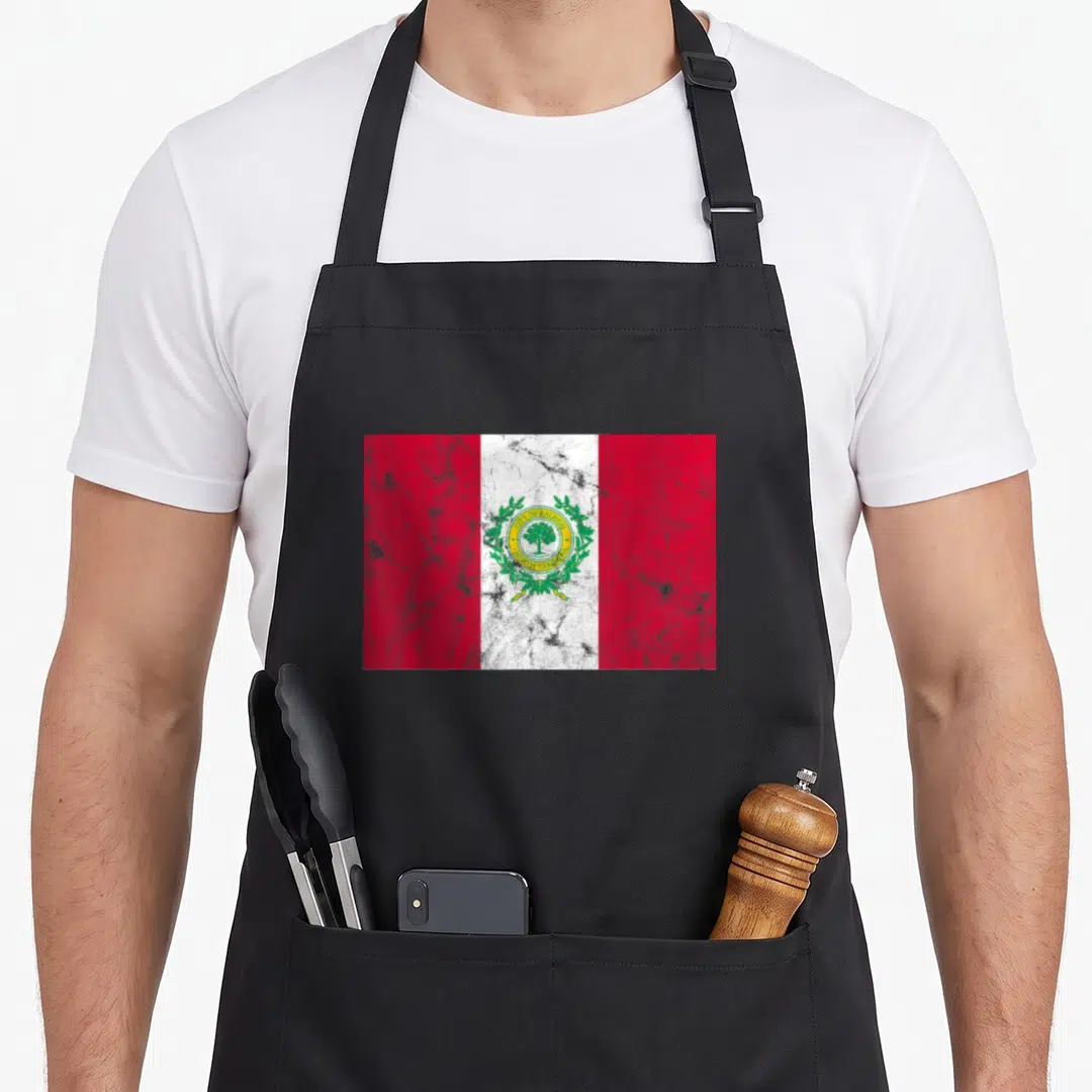 Raleigh pride apron - Distressed red white and red flag with circular seal reading City of Raleigh North Carolina — shown on a black cotton canvas apron against a white background