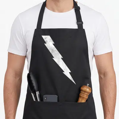 Pietro halloween apron - White distressed lightning bolt centered on black fabric background — shown on a black cotton canvas apron against a white background