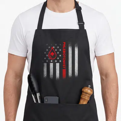 Phlebotomist us aprons - Vertical PHLEBOTOMIST text next to red blood drop with cross on distressed stars and stripes — shown on a black cotton canvas apron against a white background