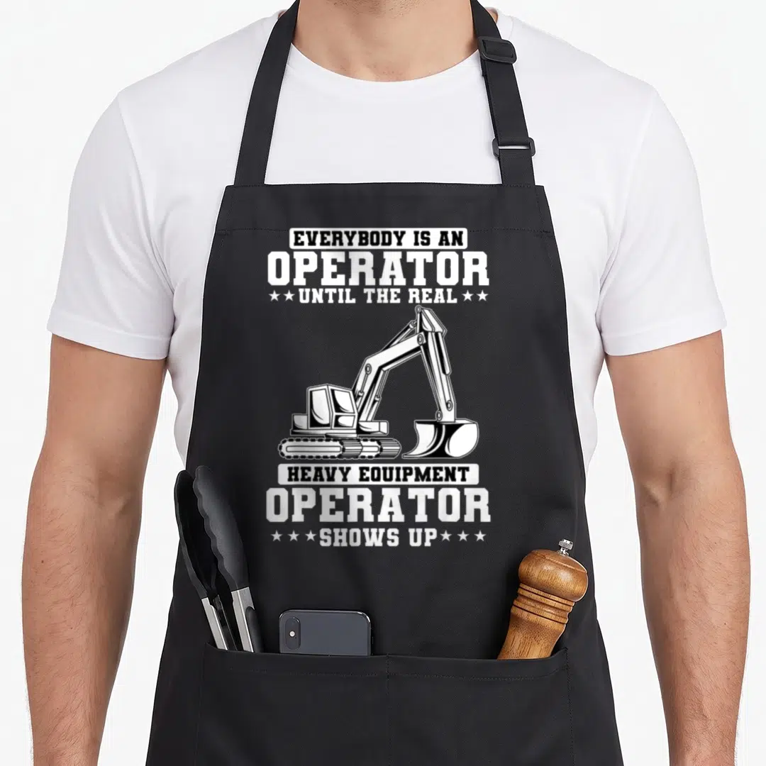 Construction excavator heavy canvas aprons - Black and white excavator illustration with stacked text and stars — shown on a black cotton canvas apron against a white background