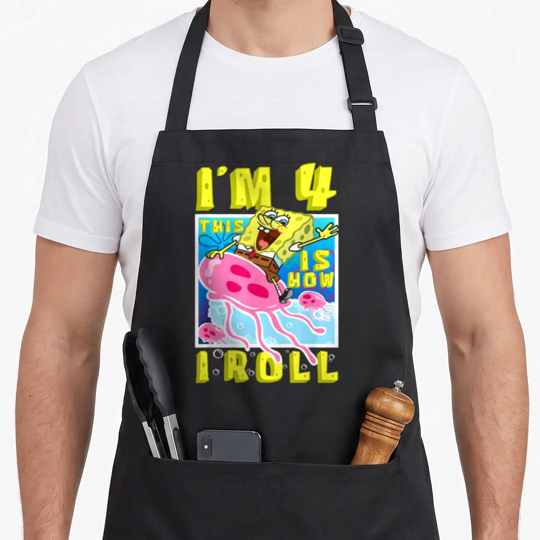 Roll birthday apron - SpongeBob riding pink jellyfish with text I'M 4 THIS IS HOW I ROLL in yellow and blue — shown on a black cotton canvas apron against a white background