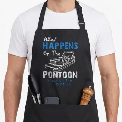 Boat pontoon lover apron - Distressed white and blue text surrounding a line drawing of a twin-hull pontoon boat — shown on a black cotton canvas apron against a white background