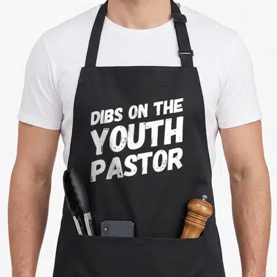 Sweet wife apron - White stacked text reading DIBS ON THE YOUTH PASTOR — shown on a black cotton canvas apron against a white background
