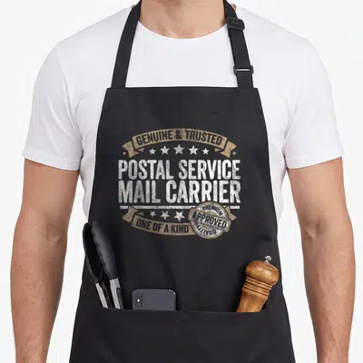 Mail service apron - Distressed white and tan badge reading Genuine Trusted Postal Service Mail Carrier Approved Quality — shown on a black cotton canvas apron against a white background