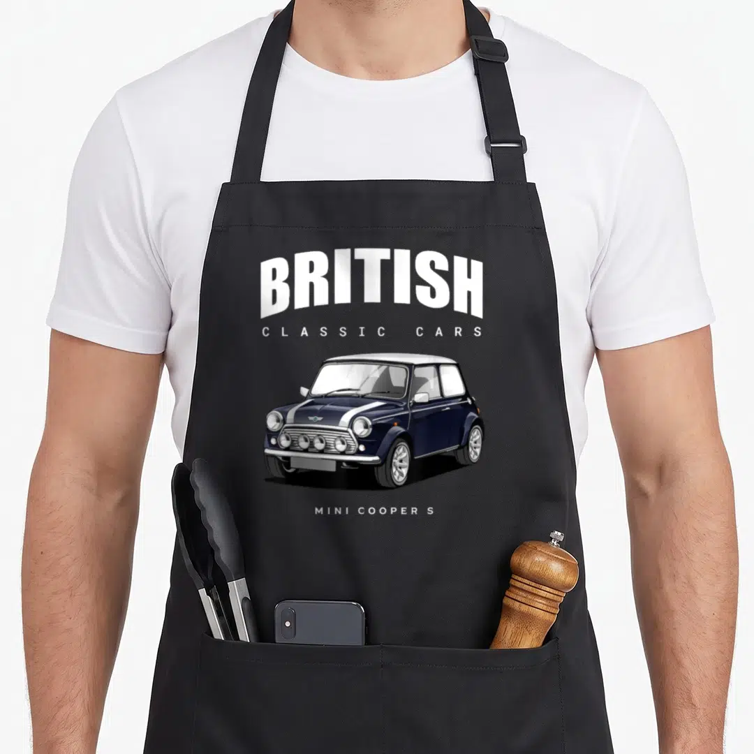 Funny sport car apron - Arched British Classic Cars text above a navy blue Mini Cooper S with white racing stripes — shown on a black cotton canvas apron against a white background