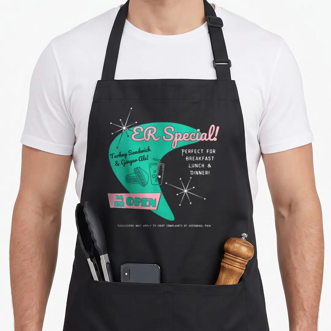 Parody nurse apron - Retro teal and pink ER Special diner menu with sandwich and ginger ale art — shown on a black cotton canvas apron against a white background