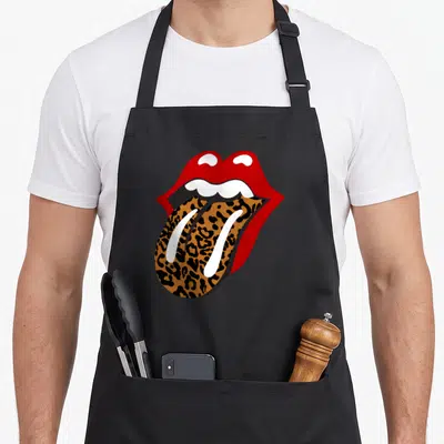 Stone leopard apron - Red open mouth with leopard print tongue and white teeth in cartoon style — shown on a black cotton canvas apron against a white background