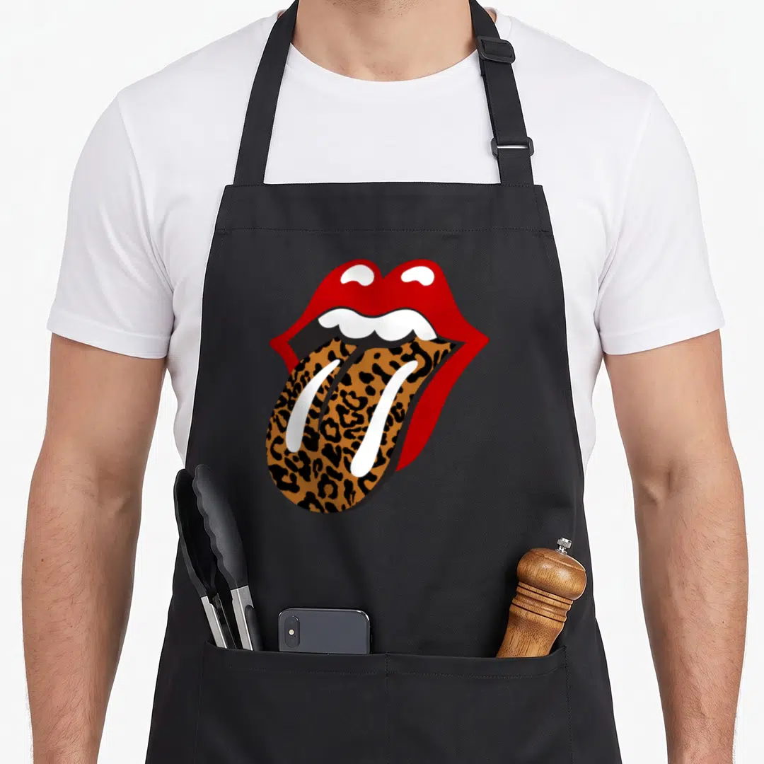 Stone leopard apron - Red open mouth with leopard print tongue and white teeth in cartoon style — shown on a black cotton canvas apron against a white background