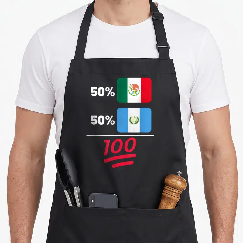 Heritage mexican apron - Stacked Guatemalan and Mexican flags next to 50% 50% 100 in white and red — shown on a black cotton canvas apron against a white background