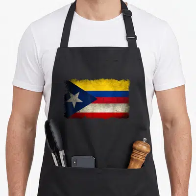 Puerto colombian apron - Distressed blended flag with blue yellow red white stripes and white star on blue triangle — shown on a black cotton canvas apron against a white background
