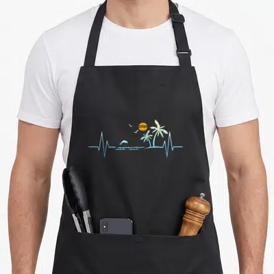 Heartbeat kitchen island apron - Minimalist blue heartbeat line forming waves, dolphin, two birds, orange sun — shown on a black cotton canvas apron against a white background