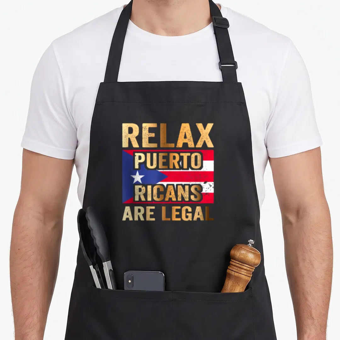 Relax ricotta apron - Retro Puerto Rican flag with gold text Relax Puerto Ricans Are Legal — shown on a black cotton canvas apron against a white background
