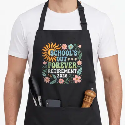 Retired school teachers apron - Retro sun and flowers surround stacked text reading SCHOOL'S OUT FOREVER RETIREMENT — shown on a black cotton canvas apron against a white background