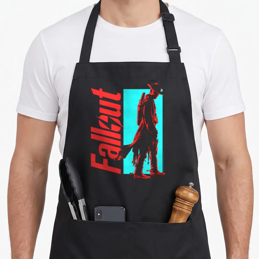 Shadow character aprons - Vertical red Fallout text beside a red figure standing against a cyan rectangle — shown on a black cotton canvas apron against a white background