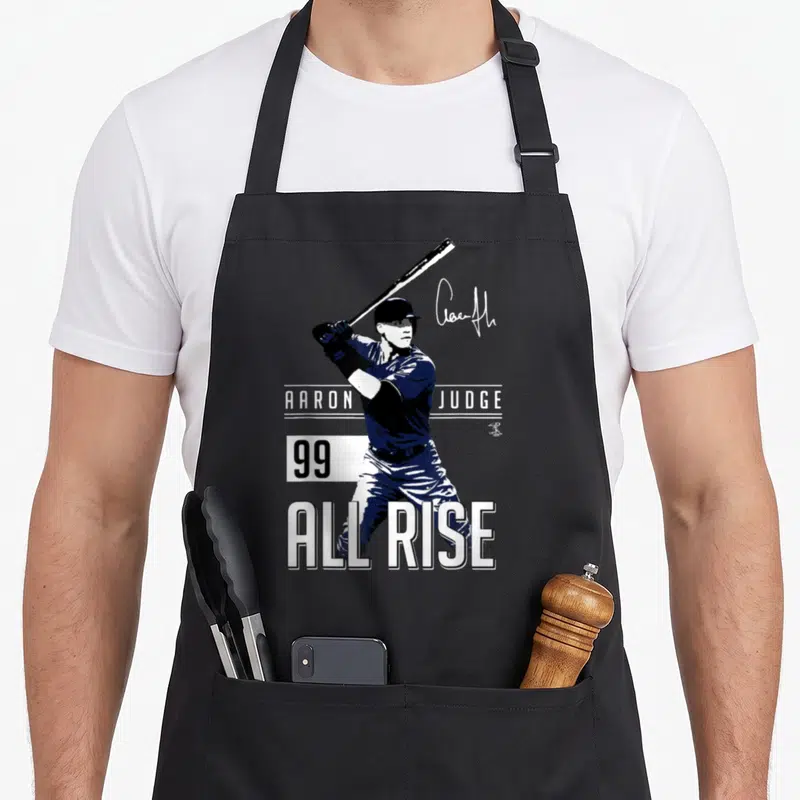Aaron york baseball apron - Aaron Judge batting graphic with All Rise text and number 99 in blue white and black — shown on a black cotton canvas apron against a white background
