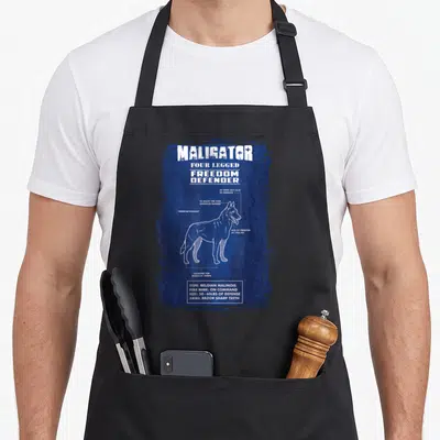 Maligator female veteran apron - Belgian Malinois technical diagram with specs like 1400 PSI bite and fur missile — shown on a black cotton canvas apron against a white background