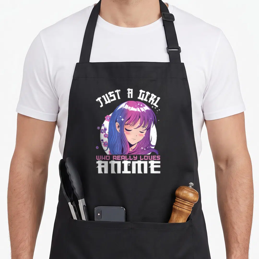 Age anime apron - Just a Girl Who Really Loves Anime text with purple pink hair cartoon girl and cherry blossoms — shown on a black cotton canvas apron against a white background