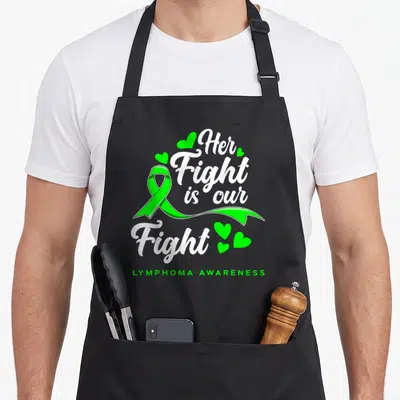 Our lymphoma awareness apron - Lime green ribbon with white script text Her Fight is our Fight and small hearts — shown on a black cotton canvas apron against a white background