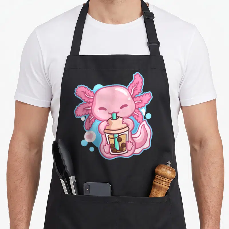 Tea anime apron - Pink axolotl drinking bubble tea with blue bubbles and a heart — shown on a black cotton canvas apron against a white background
