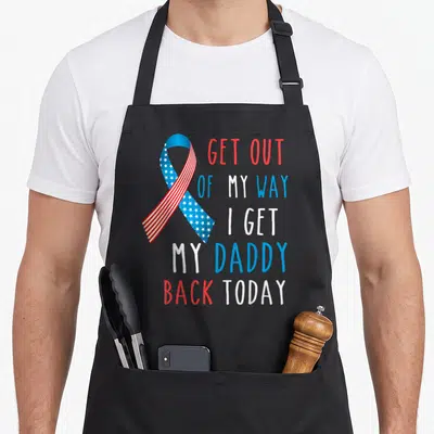 Way daddy apron - Patriotic awareness ribbon with stars stripes and stacked text reading Get Out Of My Way I Get My — shown on a black cotton canvas apron against a white background