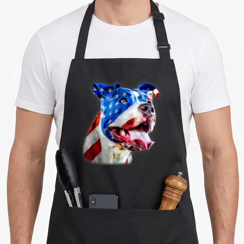 Pit dog dad apron - Watercolor pit bull head painted in blue white and red flag colors — shown on a black cotton canvas apron against a white background