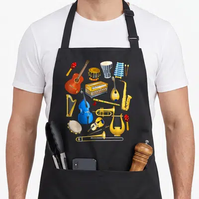 Musical harp apron - Cartoon cluster of gold blue red yellow musical instruments including harp, guitar, and drums — shown on a black cotton canvas apron against a white background
