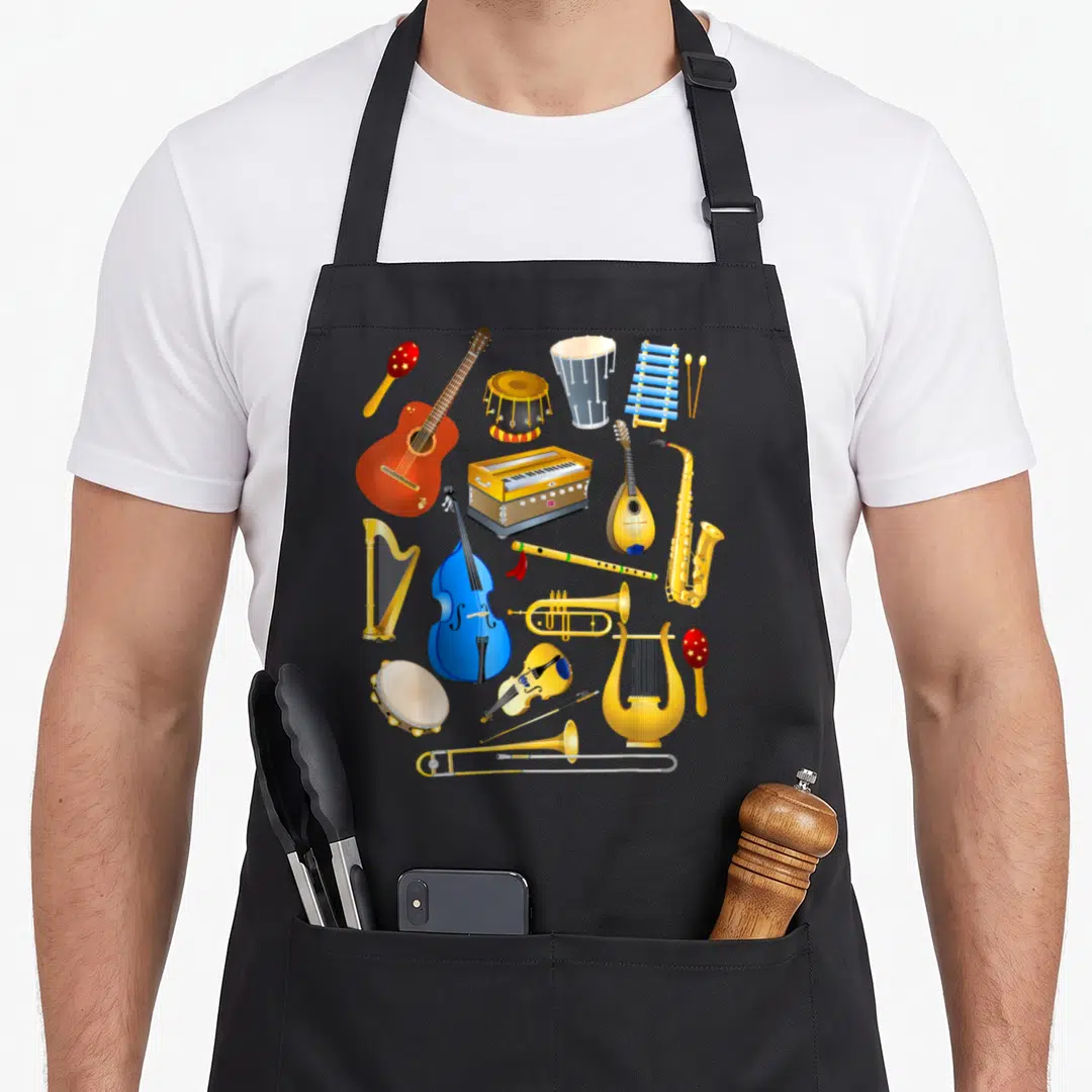 Musical harp apron - Cartoon cluster of gold blue red yellow musical instruments including harp, guitar, and drums — shown on a black cotton canvas apron against a white background